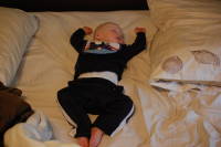 dsc_3059.jpg Devin hogs his parents' bed to catch some sleep in preparation of his cousins' visit.