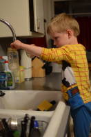 dsc_4656.jpg Devin helps out by washing Grant's bottles at night.